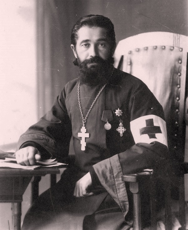 Православный священник с тремя типами крестов: наперсным на цепи, орденским знаком и символом «Красного креста» на повязке. Фото: Общественное достояние.